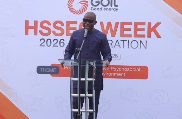 Edward-Bawa | Ghanaguardian.com Man in a dark purple outfit speaks at a transparent podium on a stage, with a banner reading 'HSSE WEEK 2026' and the 'Goil Good energy' logo in the background.