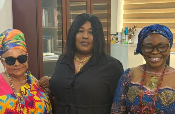 IMG-20260423-WA0080-1 | Ghanaguardian.com Three women posing together indoors; middle woman in black with a cross necklace flanked by women in colorful head wraps and patterned outfits.