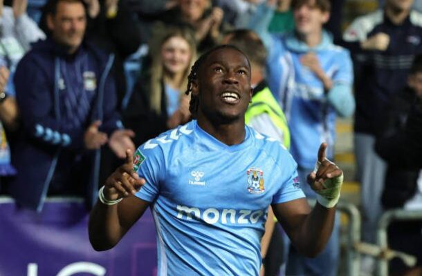 IMG_0294 | Ghanaguardian.com Soccer player in light-blue kit raises both arms in celebration as fans cheer behind him.