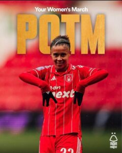 Female footballer in a red striped kit posing with hands on hips under a large 'POTM' title and 'Your Women's March' banner.