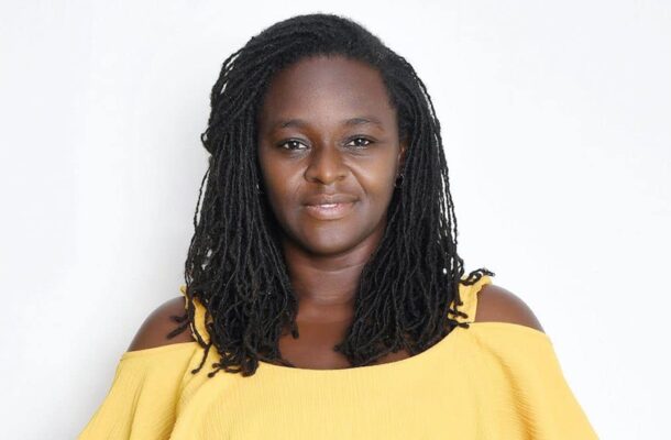 Portrait of a woman with braided hair wearing a yellow off-the-shoulder top, facing the camera against a white background.