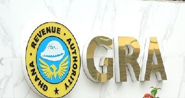 GRA sign: circular Ghana Revenue Authority logo beside large gold letters 'GRA' on a marble wall.