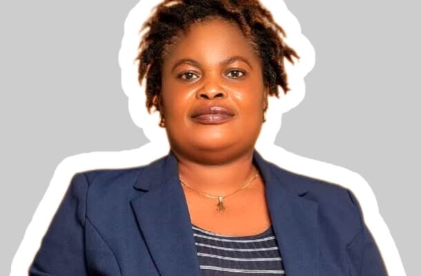 Abamba queenmother | Ghanaguardian.com Professional head-and-shoulders portrait of a Black woman in a navy blazer and striped top against a neutral gray background.
