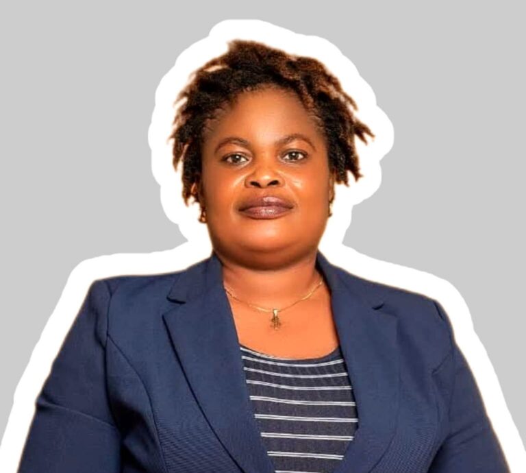 Professional head-and-shoulders portrait of a Black woman in a navy blazer and striped top against a neutral gray background.