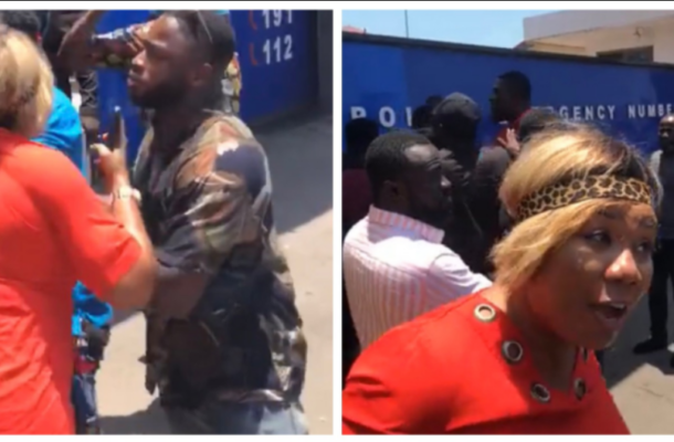 Bidget Otoo demo | Ghanaguardian.com Two people arguing in a street; a woman in red blouse faces a man in camouflage as onlookers watch.