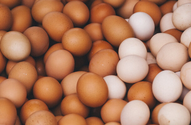 Pile of brown and white eggs filling the frame.