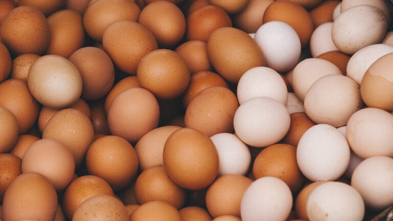Pile of brown and white eggs filling the frame.