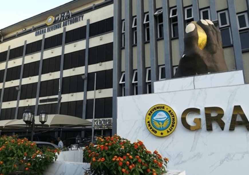 Exterior view of the Ghana Revenue Authority (GRA) building with a large marble display and the GRA logo and emblem in front.