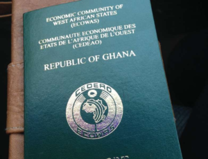 Green/teal Ghana Republic passport with gold embossed text and emblem, ECOWAS dialogue at top, 'REPUBLIC OF GHANA' center, circular emblem near bottom.