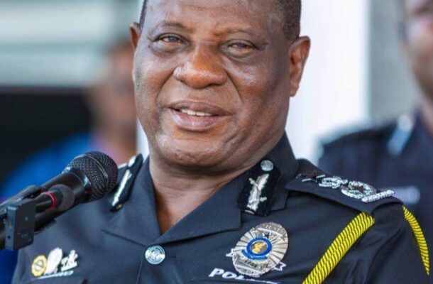Senior police officer in uniform speaking into a microphone at a public event