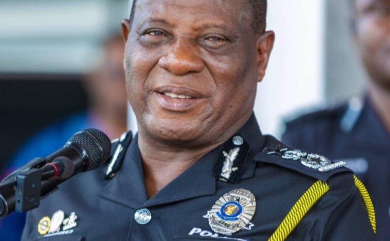 Senior police officer in uniform speaking into a microphone at a public event