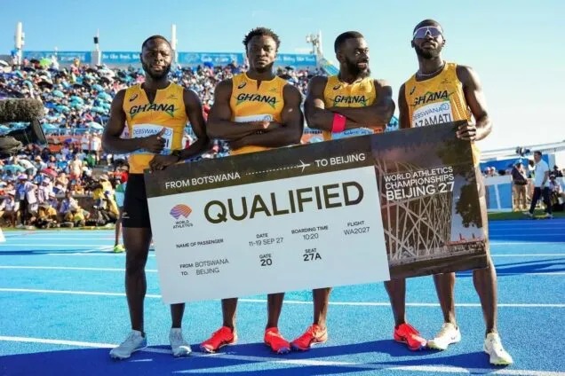 Four Ghanaian sprinters on a blue track hold a large banner that reads 'QUALIFIED' for the World Athletics Championships in Beijing, with the slogan 'From Botswana to Beijing.'