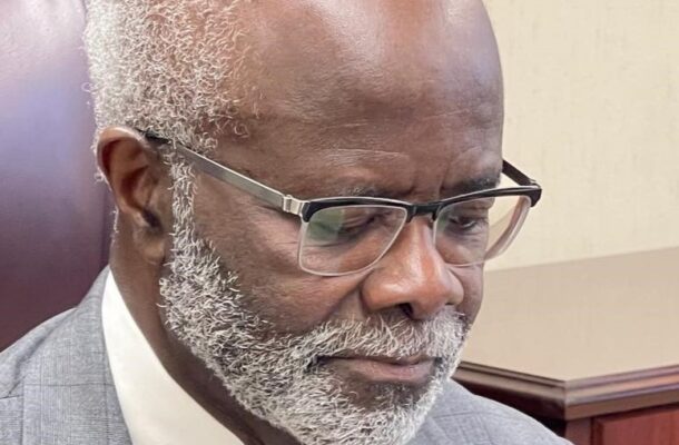 IMG-20260527-WA0030-1 | Ghanaguardian.com Close-up of an older Black man with a gray beard and glasses, wearing a gray suit, looking down thoughtfully.