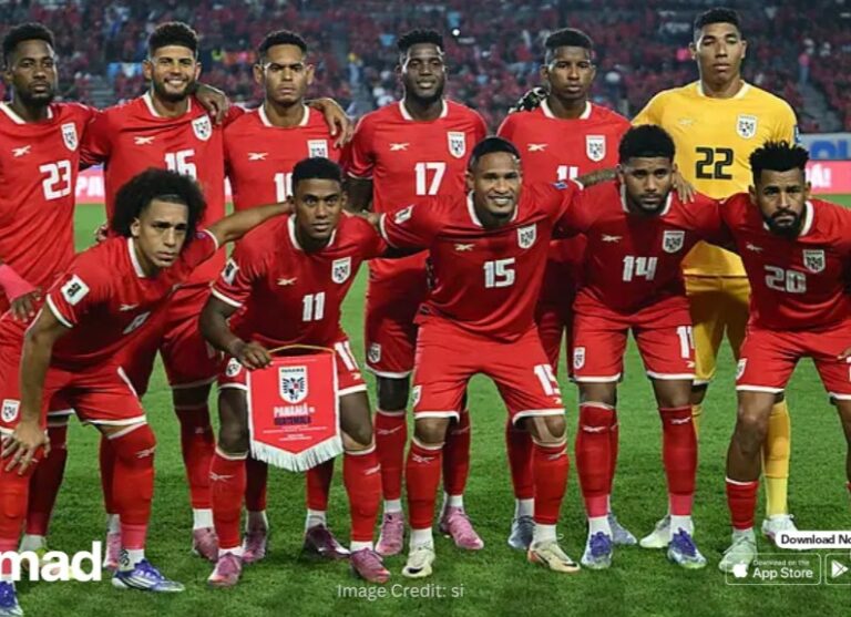 Panama national football team posing for a group photo on the pitch, players in red kits with white numbers and a yellow-clad goalkeeper in back.