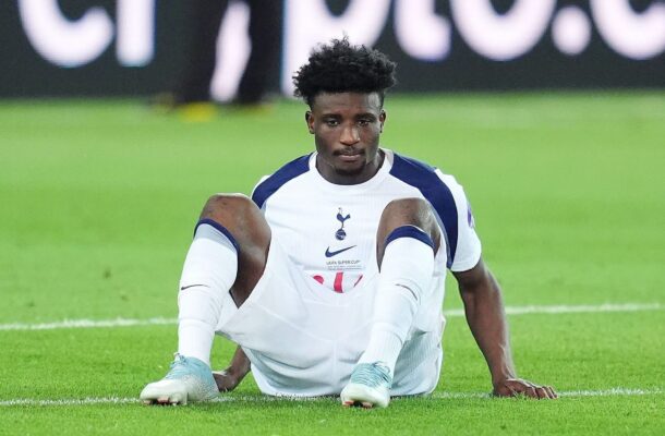 IMG_0130 | Ghanaguardian.com Soccer player in a white and navy kit sitting on the grass with hands on the ground, looking at the camera.