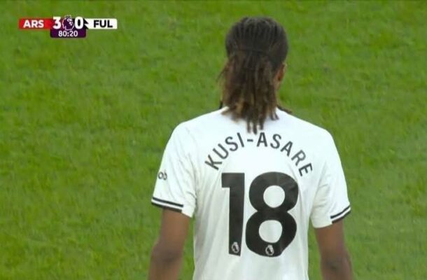 Back view of a soccer player in a white jersey with 'KUSI-ASARE' and the number 18; green field and a scoreboard showing Arsenal 3, Ful 0.