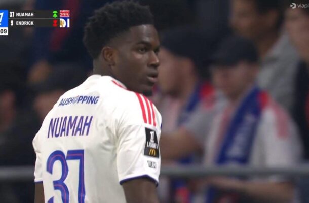 Soccer player Nuamah (number 31) in a white jersey, turning to look over his shoulder during a match with a stadium crowd in the background.