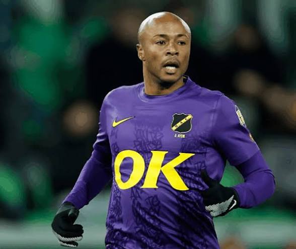 Male soccer goalkeeper in a purple kit with yellow 'OK' sponsor, mid-action on the field.