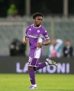 Soccer player in a purple kit sprinting on the field, number 81 on the shorts, white accents and cleats visible.