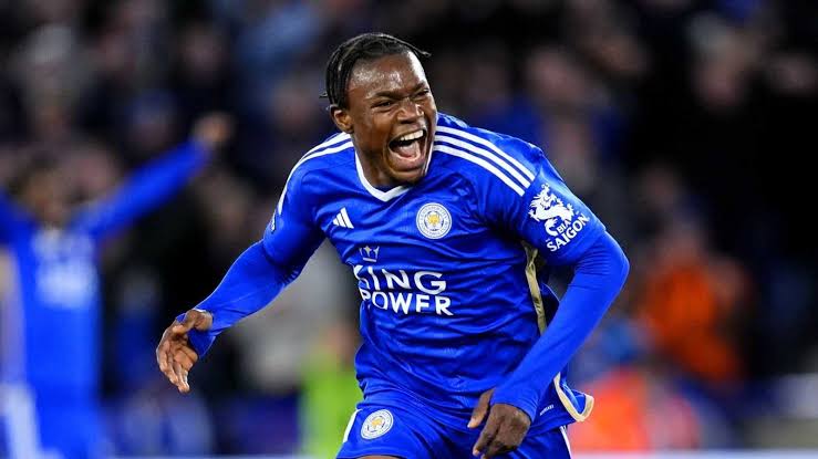 Footballer in a blue Leicester City jersey celebrating a goal on the pitch.