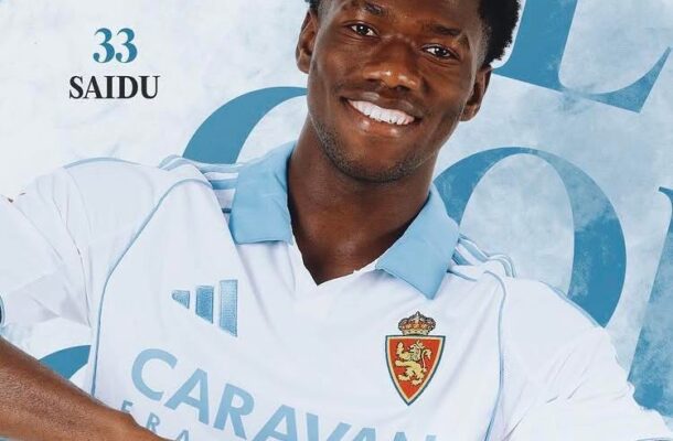 IMG_0587 | Ghanaguardian.com Smiling man in a light blue and white soccer jersey gesturing with fists, with ‘SAIDU 33’ in the background and team crest on sleeve.