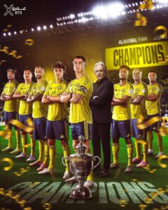 Soccer team in yellow uniforms posing on a lit stadium field with a large 'CHAMPIONS' banner in back; a coach stands among players and a trophy sits at the foreground.
