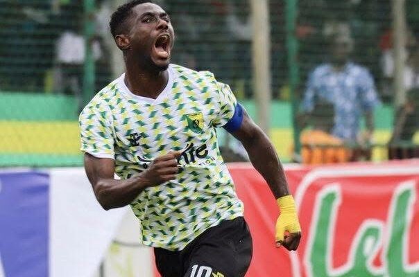 IMG_0658 | Ghanaguardian.com Soccer player in a green-yellow patterned jersey celebrates with mouth open and fist raised on the field.