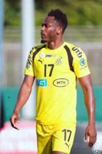 Baba Rahman | Ghanaguardian.com Soccer player in a bright yellow jersey with number 17, standing outdoors and looking to the left.