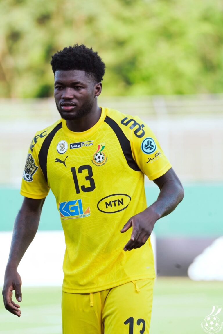 Male soccer player in a bright yellow jersey with number 13, on a green outdoor field, mid-action.