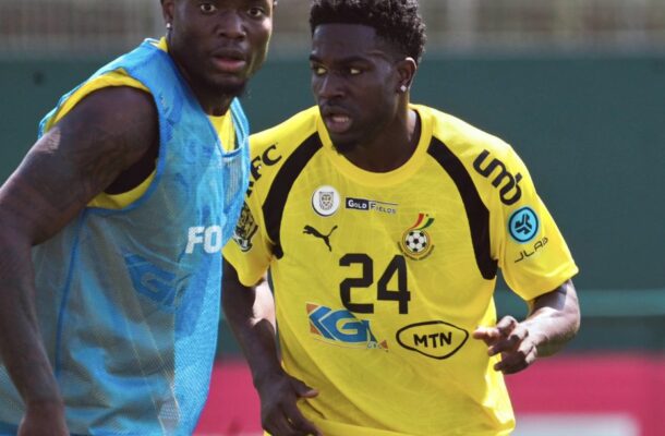 IMG_0762 | Ghanaguardian.com Two male soccer players training on a field, one in a yellow jersey (#24) and the other in a blue bib, facing each other closely.