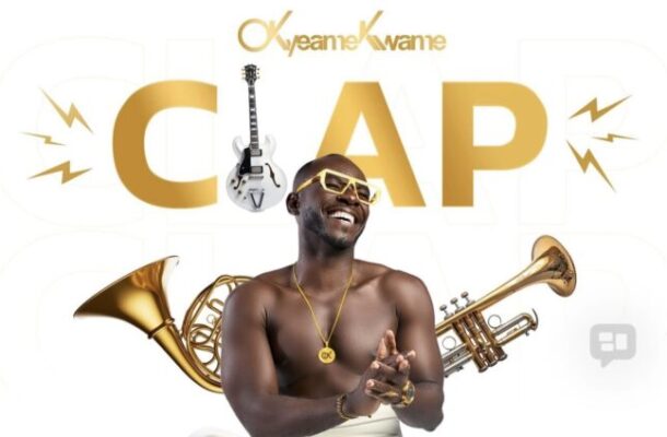 Smiling Black man with gold jewelry, shirtless, surrounded by brass instruments (trumpet, trombone) and a guitar, with a large gold 'CAP' in the background.