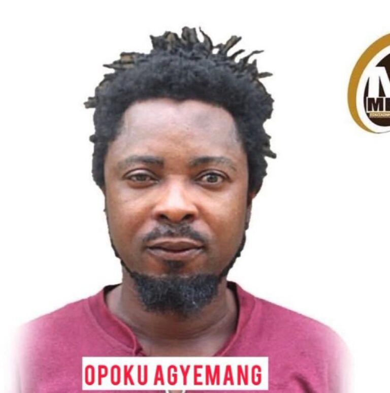 Portrait of Opoku Agyemang with short dreadlocks and a goatee, wearing a red shirt on a white background with a partial circular logo to the right.