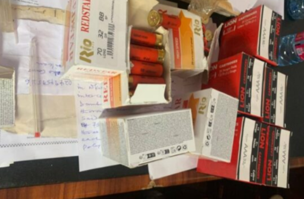 Cluttered desk with assorted medicine boxes and blister packs; colors red and white dominate, with some pills visible.