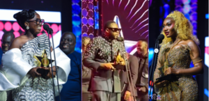 Three award winners on stage: left a woman in a white gown holding a star trophy at the mic, center a man in a suit accepting an award, right a woman in a gold dress holding a trophy.