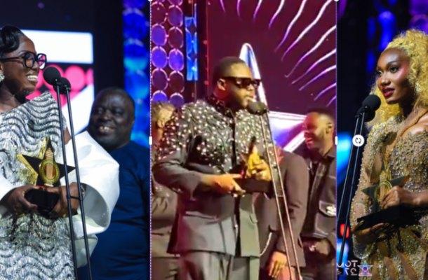 TGMA 27 | Ghanaguardian.com Three award winners on stage: left a woman in a white gown holding a star trophy at the mic, center a man in a suit accepting an award, right a woman in a gold dress holding a trophy.