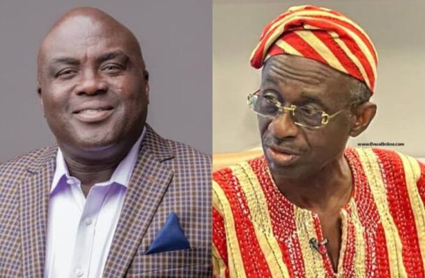 WhatsApp-Image-2026-04-21-at-114009 | Ghanaguardian.com Two men side by side: one in a checkered blazer and light shirt smiling, the other in red-gold traditional clothing with a headwrap and glasses looking to the side.