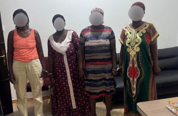 Four women with blurred faces pose indoors against a light wall, each wearing a distinct colorful dress.