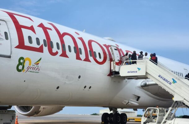 Passengers boarding an Ethiopian Airlines aircraft via mobile stairs labeled Aviance on a sunny tarmac.