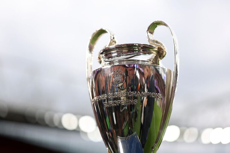 Shiny silver European club champions trophy with curved handles and engraved text on the front europeens logo visible.