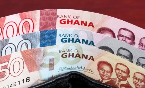 Fanned Ghanaian banknotes (50, 100, 200 cedis) showing Bank of Ghana branding and portraits in a wallet.