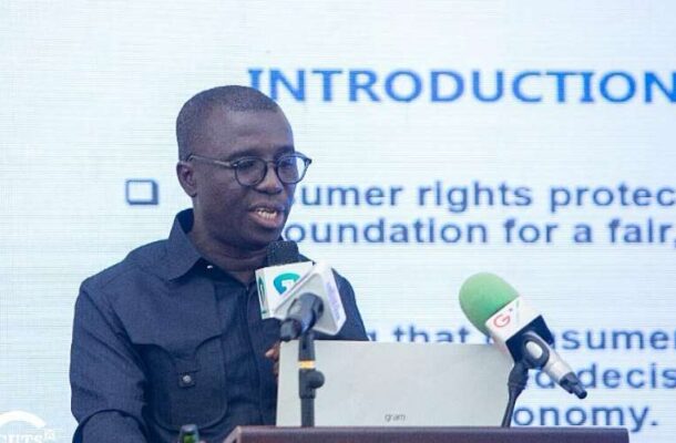 cuts | Ghanaguardian.com Man with glasses speaking at a podium with a laptop and two microphones, a slide behind him reads 'INTRODUCTION'.