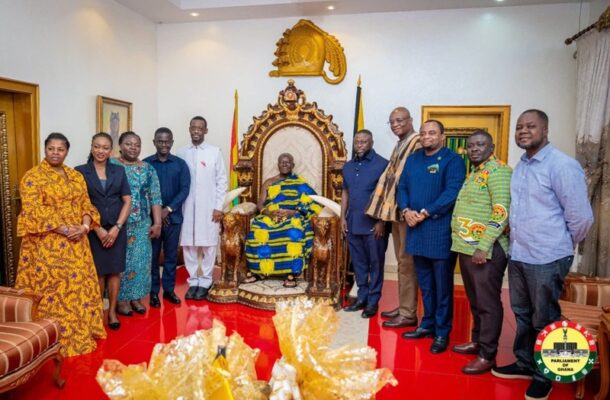 otumfuo | Ghanaguardian.com Group of officials posing with a seated dignitary on an ornate throne in a ceremonial room, Ghanaian flags in the background and a crest on the wall.