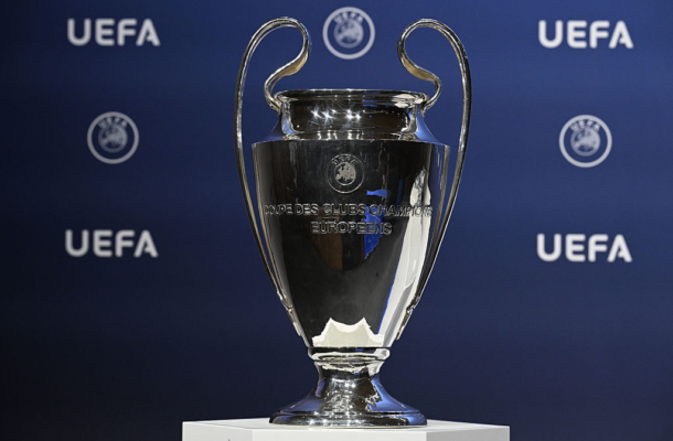Silver European Cup trophy on a pedestal, engraved 'Coupe des Clubs Champions Européens', with a blue UEFA backdrop