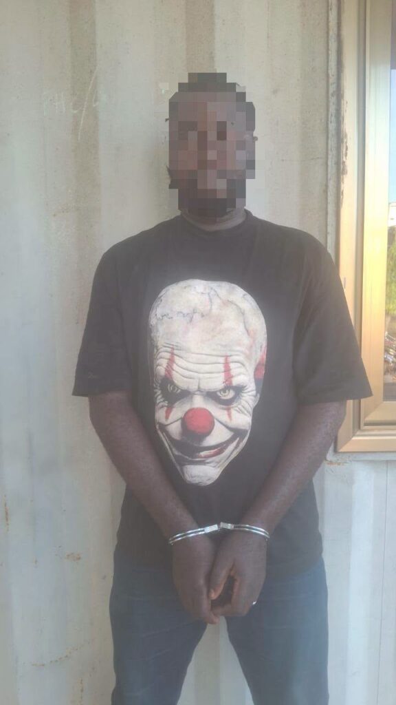 714852913_2515739408880225_5202104310161350593_n-576x1024 | Ghanaguardian.com Man with blurred face standing against a wall, wearing a black T‑shirt with a clown face design and his hands cuffed in front.