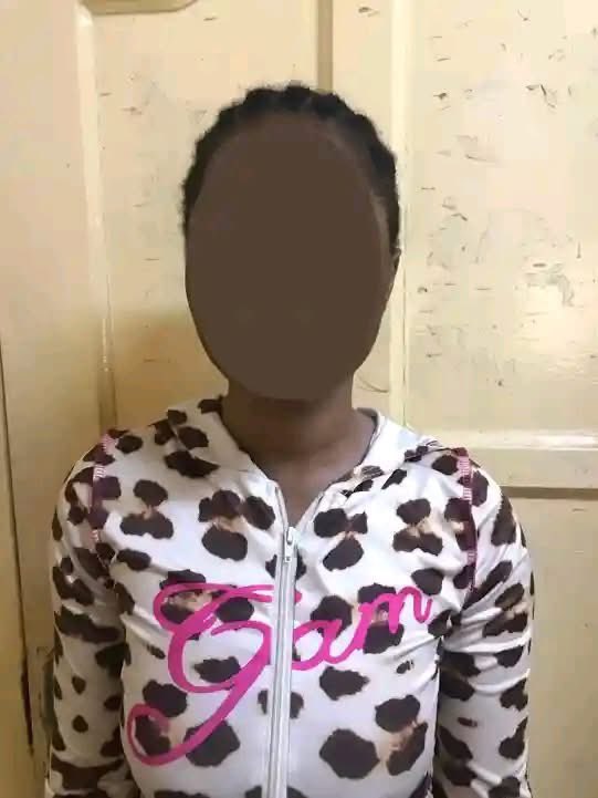 Person wearing a white leopard‑print zip sweatshirt with pink 'Glam' text, standing indoors; their face is blurred.
