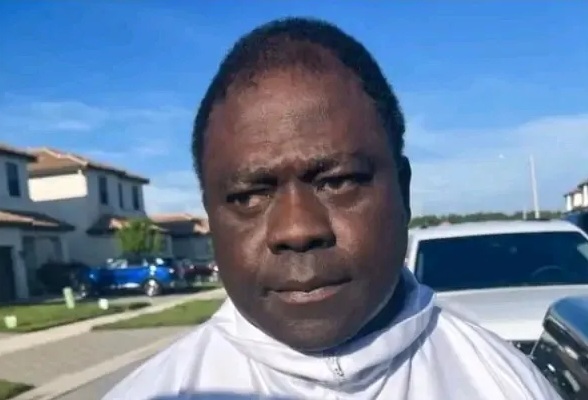 Anthony-Odiong-PHOTO-Facebook | Ghanaguardian.com Close-up of a dark-skinned man with a serious expression, wearing a light jacket, on a sunny suburban street.