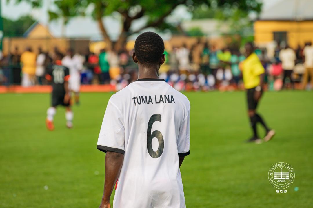 IMG-20260608-WA0003 | Ghanaguardian.com Soccer player seen from behind on a grassy field, white jersey with 'TUMA LANA' and number 6, spectators in the background.