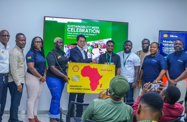 IMG-20260614-WA0017 | Ghanaguardian.com Group of people at a sustainability event presenting a oversized Shell card donation to Vivo Energy Ghana staff and attendees in a conference room. Same banner reads 'Sustainability Week Celebration'.