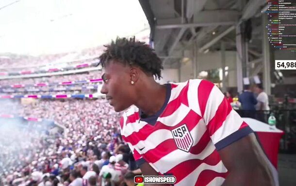 IMG-20260614-WA0026 | Ghanaguardian.com Man in a red‑white USA striped jersey leans over a railing at a packed stadium, crowd cheering behind him.