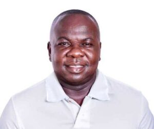 Smiling man in a white polo shirt posing for a portrait against a white background, suitable as a headshot